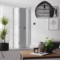 white bifold door in a room with a few plants, a coffee table with a candle and a hanging pendant light