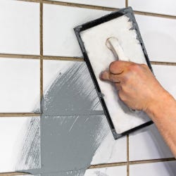 wall tiles being grouted